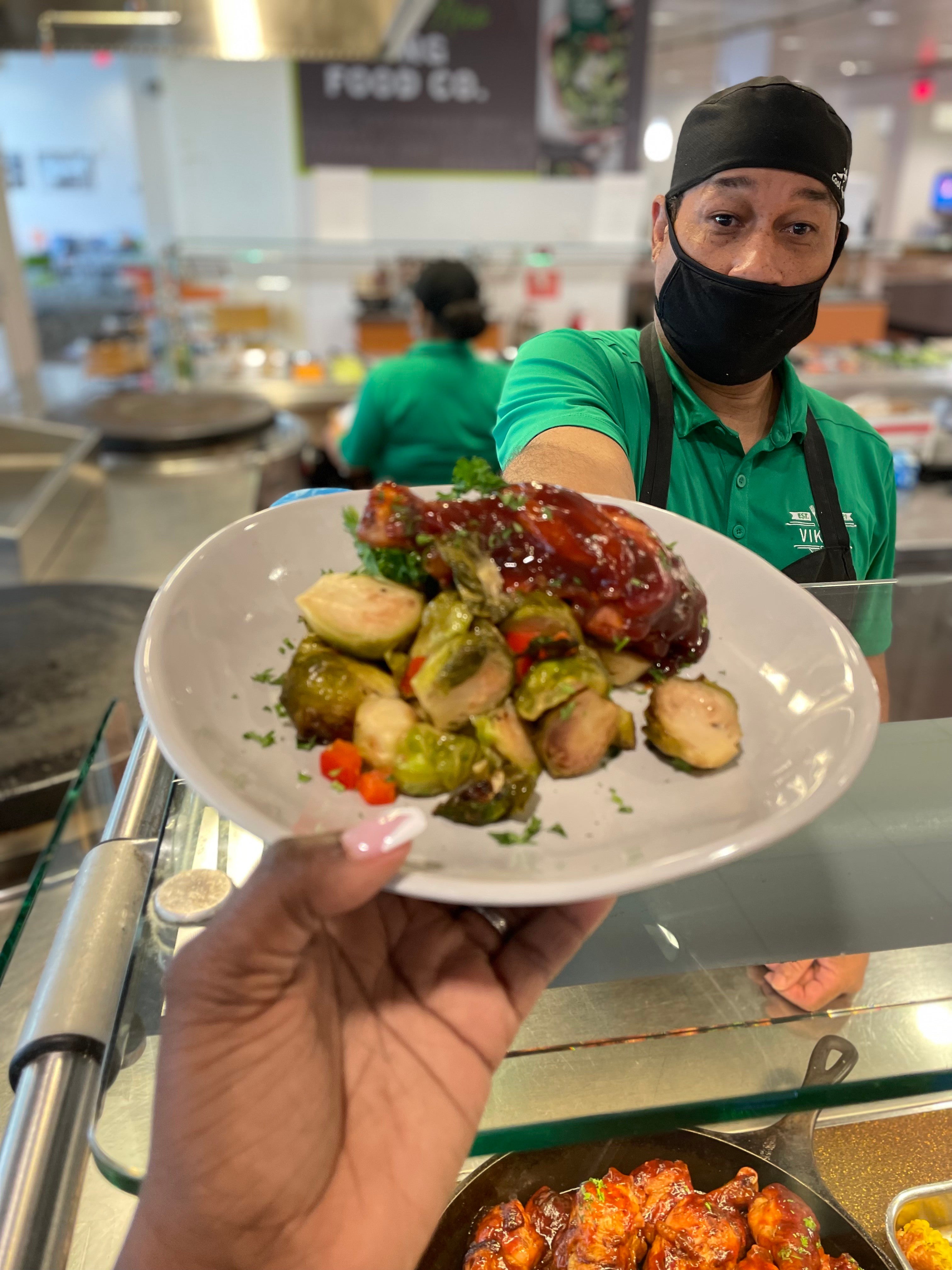 Dining staff serving a plate of food