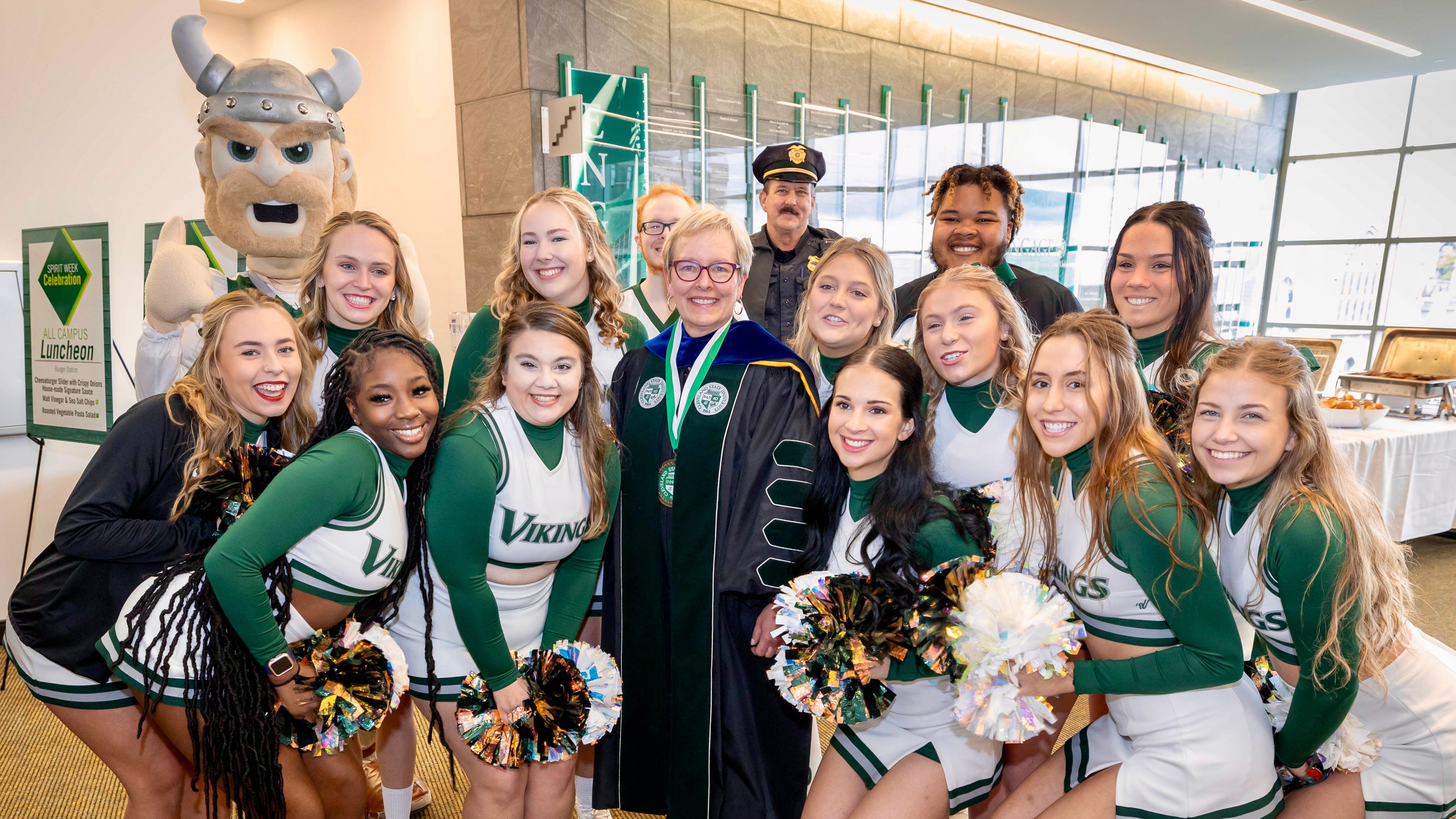 Pres Bloomberg with cheerleaders