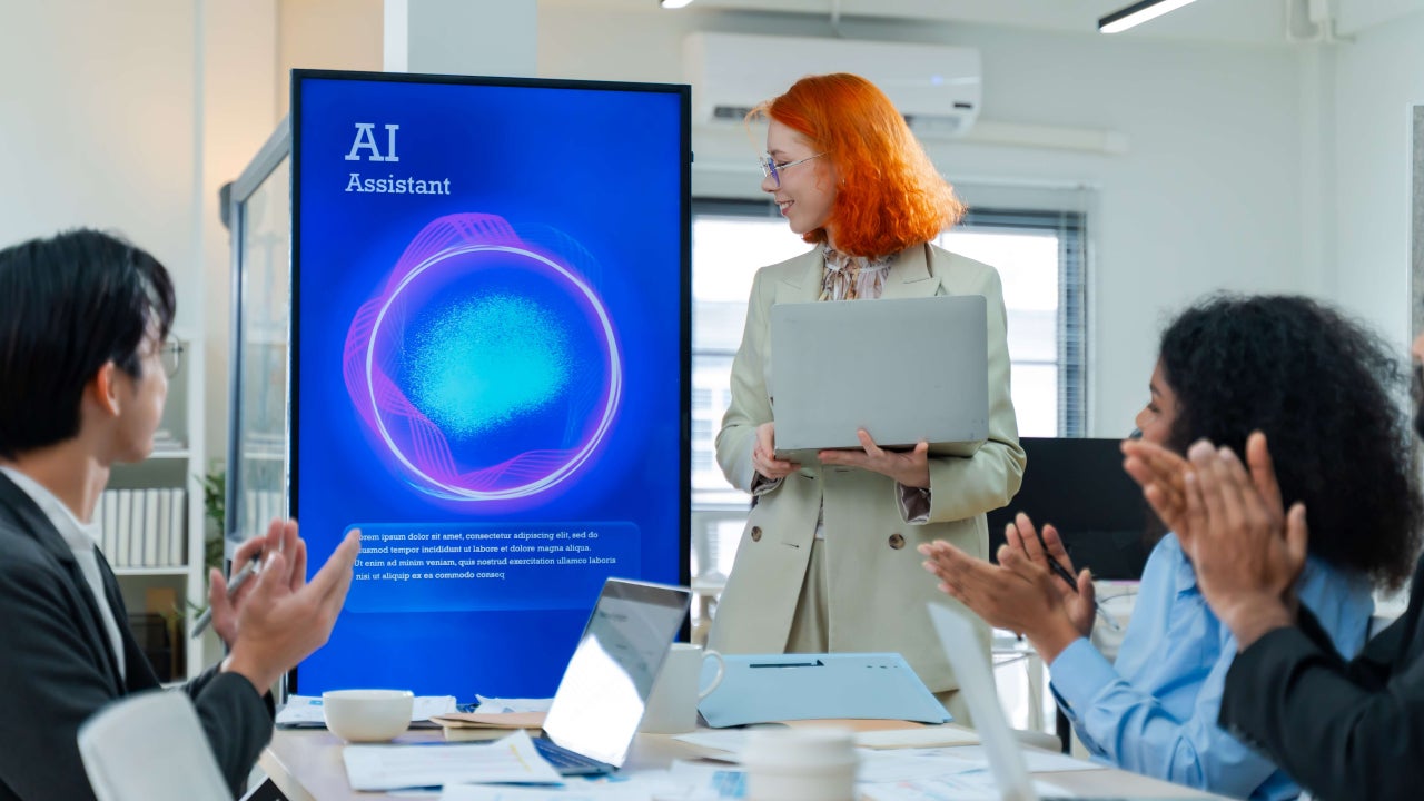 A woman presenting in a meeting using an AI agent on a screen.
