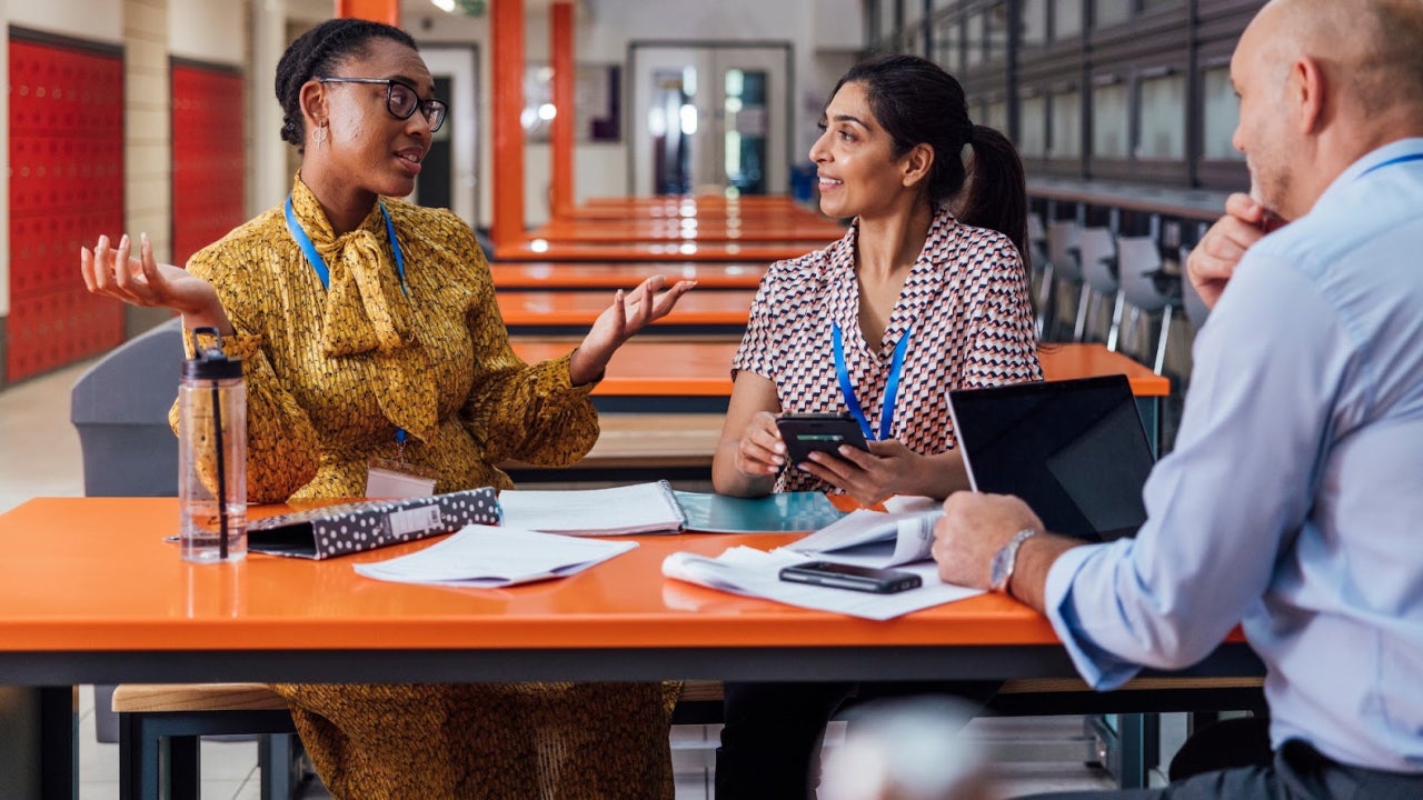 Group of teachers talking around a table