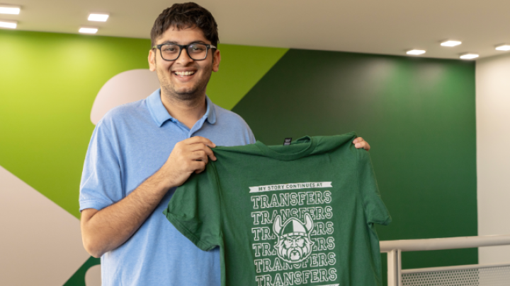 Male student holding Transfer t-shirt