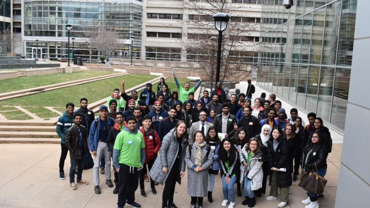 Students gather in the plaza for a photo on the day of international student orientation