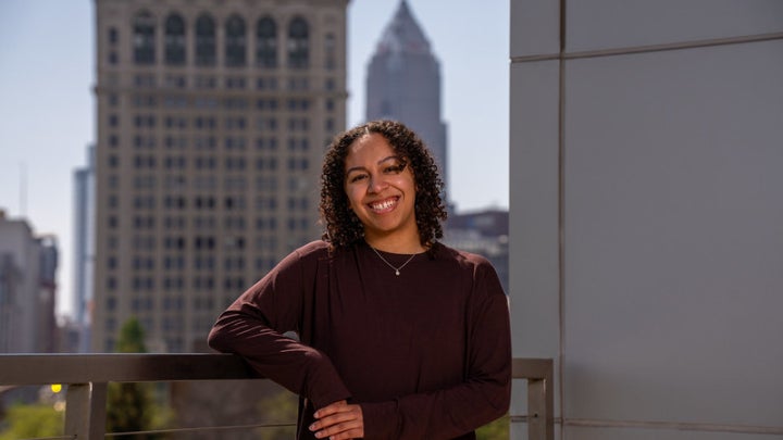 Leilah Flores posing in front of Cleveland skyline 
