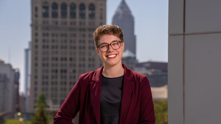 Grace Moon posing in front of Cleveland skyline