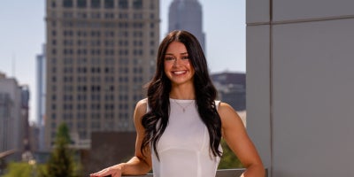 Sydney Wisno posing in front of CSU skyline