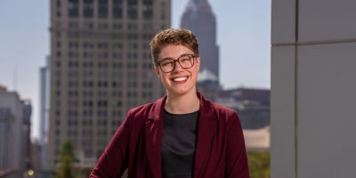Grace Moon posing in front of Cleveland skyline