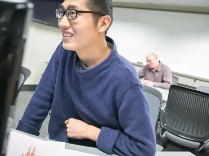 Student smiles in classroom