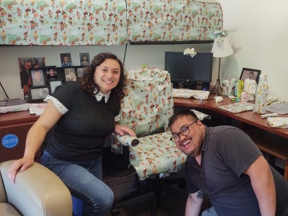 Two interns in an office where everything has been wrapped in wrapping paper as a prank