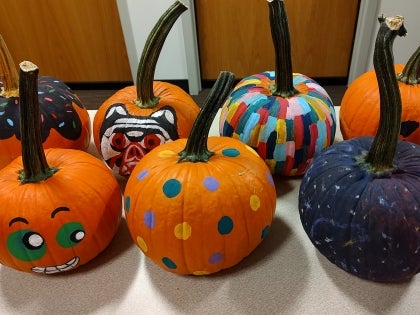 Grouping of 7 painted pumpkins