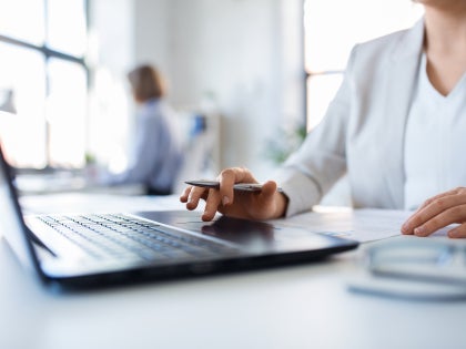 A person sitting in front of a computer