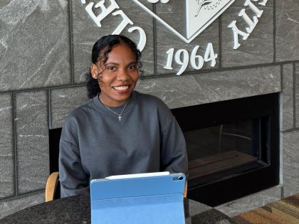 female student at table with laptop