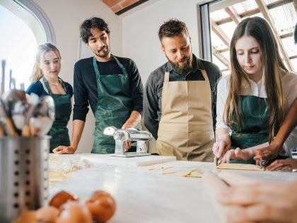 group of students receiving instruction on pasta making