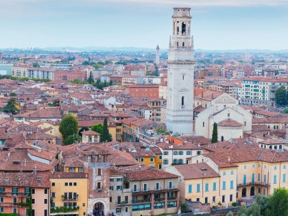 looking over a historic Italian city on the banks of a river