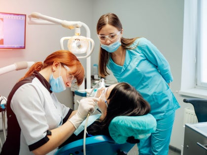 dentist and dental assistant with a patient