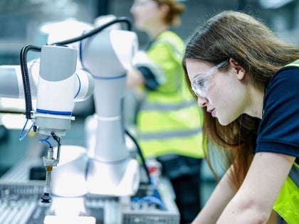 Woman operating smart technology in a manufacturing setting