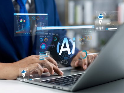 man working with AI on a laptop