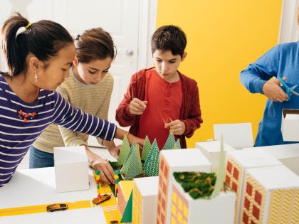 Young students in a classroom working on a project together