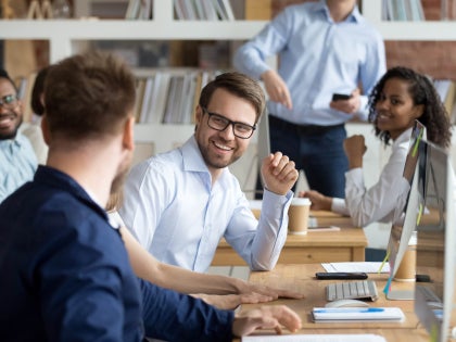 group of colleagues sitting around a table